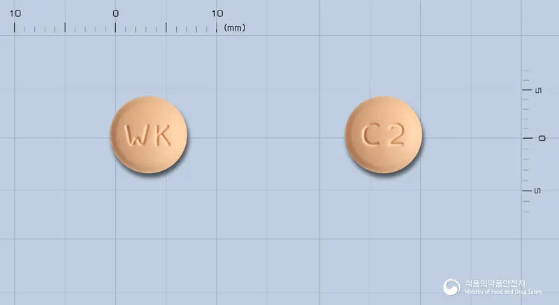 오사탄플러스정20/12.5밀리그램 앞뒤 사진 (주황색 원형, 각인 WK / C2)
