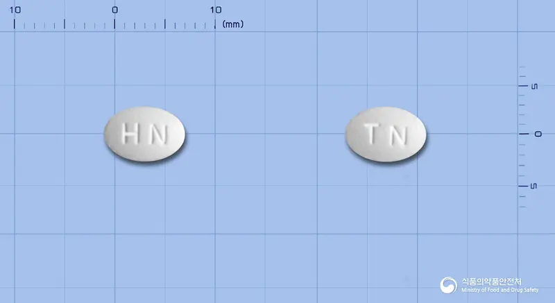 티아론정(티아넵틴나트륨) 앞뒤 사진 (흰색 타원형, 각인 HN / TN)