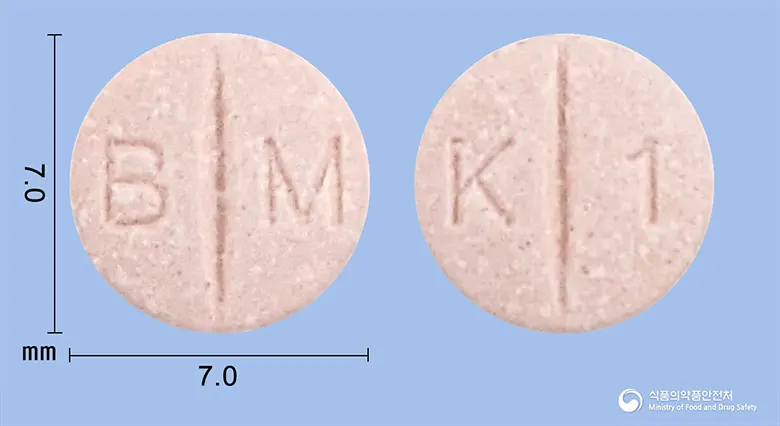 딜라트렌정3.125mg(카르베딜롤) 앞뒤 사진 (분홍색 원형, 각인 B M / K 1)