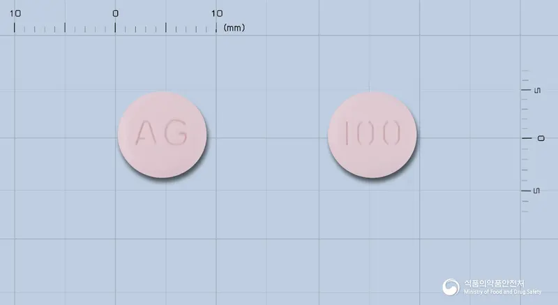 레스카펜정100밀리그램(세프카펜피복실염산염수화물) 앞뒤 사진 (분홍색 원형, 각인 AG / 100)