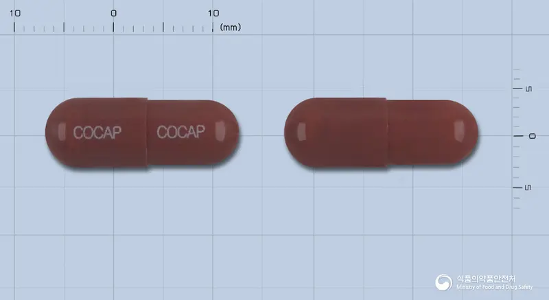 한방청코프캡슐 앞뒤 사진 (갈색 캡슐, 각인 COCAP COCAP)