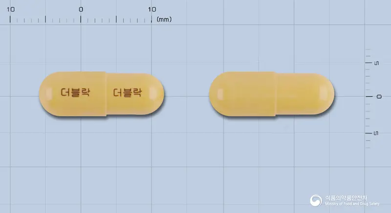 더블락캡슐 앞뒤 사진 (주황색 캡슐, 각인 더블락 더블락)