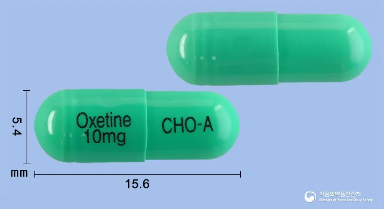 옥세틴캡슐10밀리그램(플루옥세틴염산염) 앞뒤 사진 (초록색 캡슐, 각인 Oxetine 10mg CHO-A)