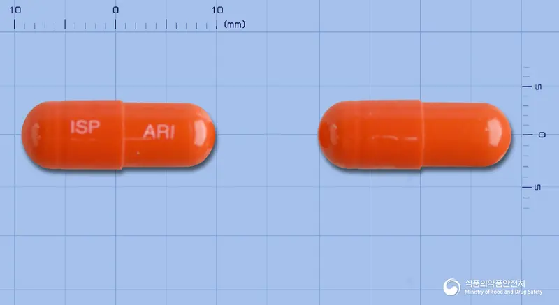 아리그렐캡슐 앞뒤 사진 (주황색 캡슐, 각인 ISP ARI)