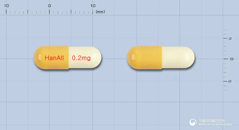 한올탐술로신캡슐(탐스로신염산염) 앞뒤 사진 (주황색 캡슐, 각인 HanAll 0.2mg)