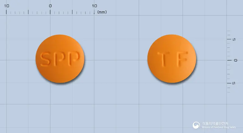 프로탈정(탈니플루메이트) 앞뒤 사진 (주황색 원형, 각인 SPP / TF)