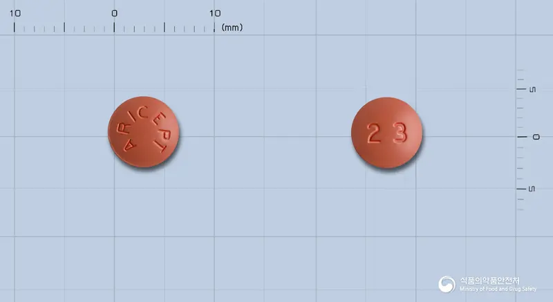 아리셉트정23밀리그램(도네페질염산염) 앞뒤 사진 (주황색 원형, 각인 ARICEPT / 23)