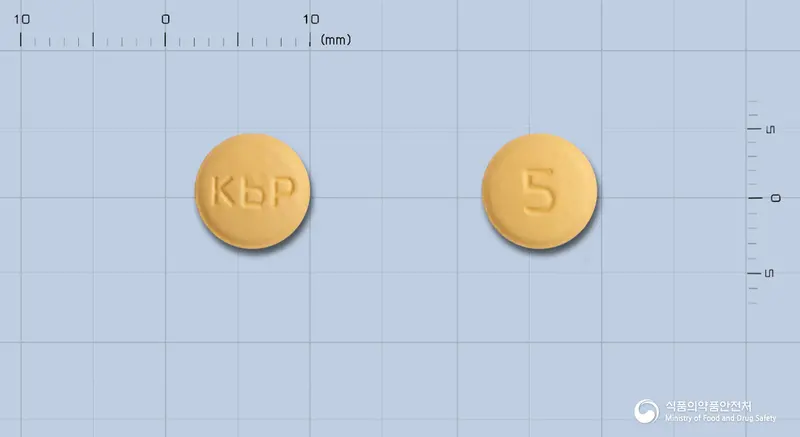 노발탄정5/80밀리그램 앞뒤 사진 (주황색 원형, 각인 KbP / 5)