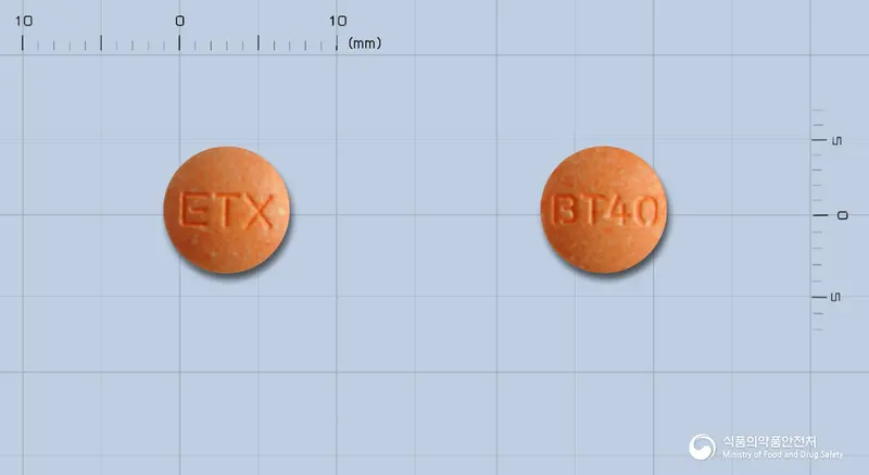 브로목틸정40mg(옥틸로늄브롬화물) 앞뒤 사진 (주황색 원형, 각인 ETX / BT40)