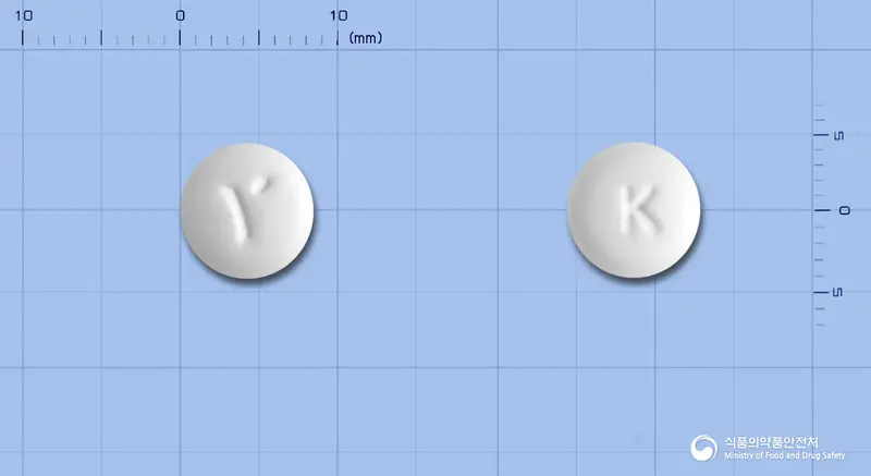 유칼린정(칼리디노게나제) 앞뒤 사진 (흰색 원형, 각인 K)