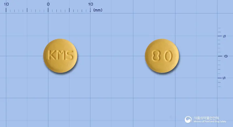 엑시비탄정5/80밀리그램 앞뒤 사진 (주황색 원형, 각인 KMS / 80)