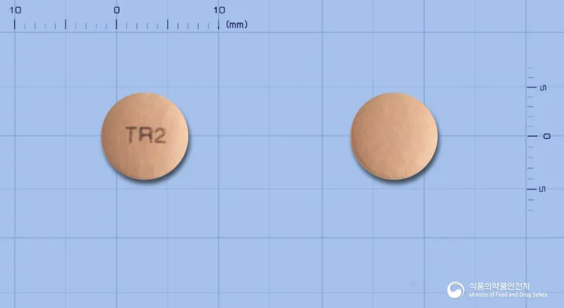 넥소프라정20mg(에스오메프라졸마그네슘이수화물) 앞뒤 사진 (분홍색 원형, 각인 TR2)