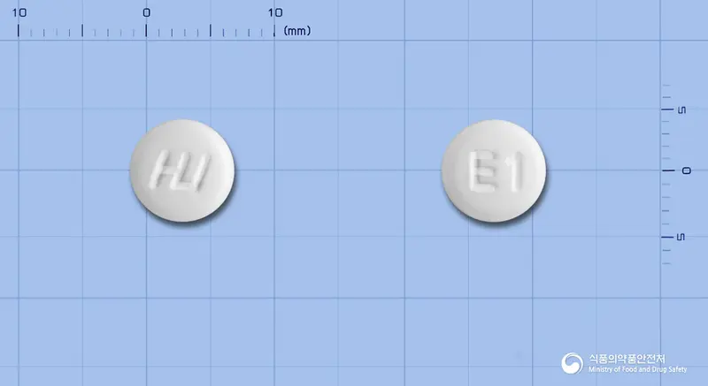 휴리손정(에페리손염산염) 앞뒤 사진 (흰색 원형, 각인 E1)