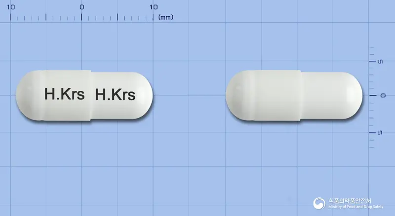 뮤테인캡슐(아세틸시스테인) 앞뒤 사진 (흰색 캡슐, 각인 H.Krs H.Krs)