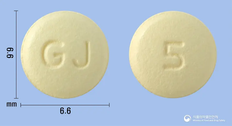 메디페나신정5mg(솔리페나신숙신산염) 앞뒤 사진 (노란색 원형, 각인 GJ / 5)