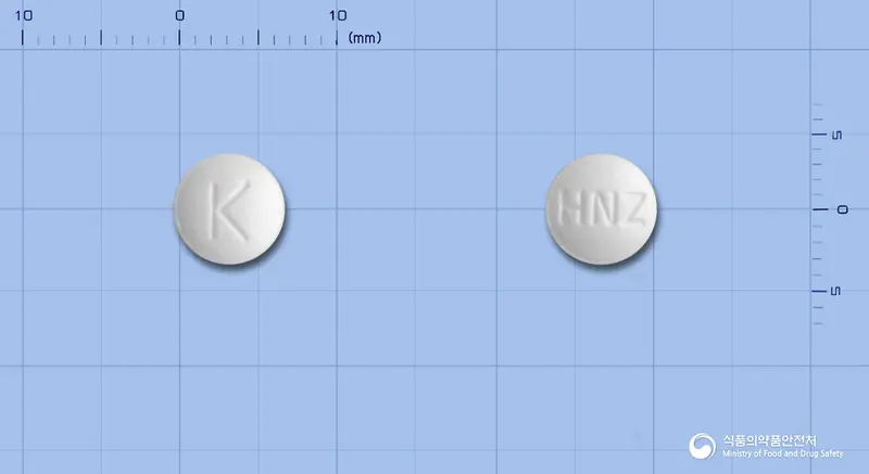 휴니즈레보설피리드정 앞뒤 사진 (흰색 원형, 각인 K / HNZ)
