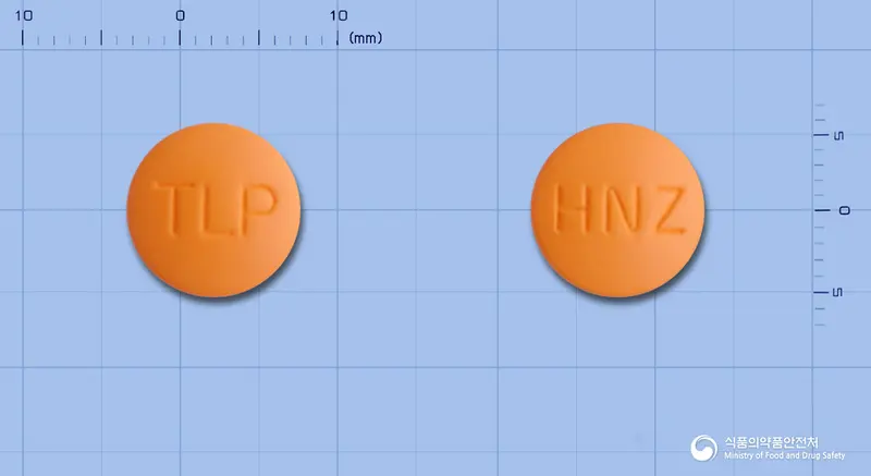 휴니즈탈니플루메이트정 앞뒤 사진 (주황색 원형, 각인 TLP / HNZ)