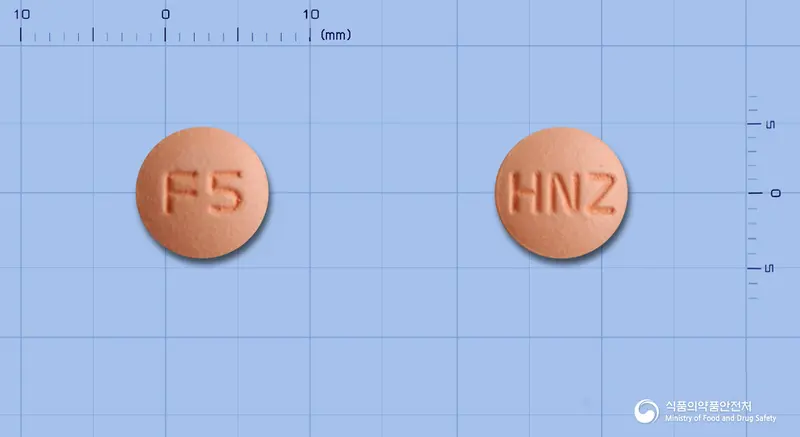 휴니즈펠로디핀지속정 앞뒤 사진 (분홍색 원형, 각인 F5 / HNZ)