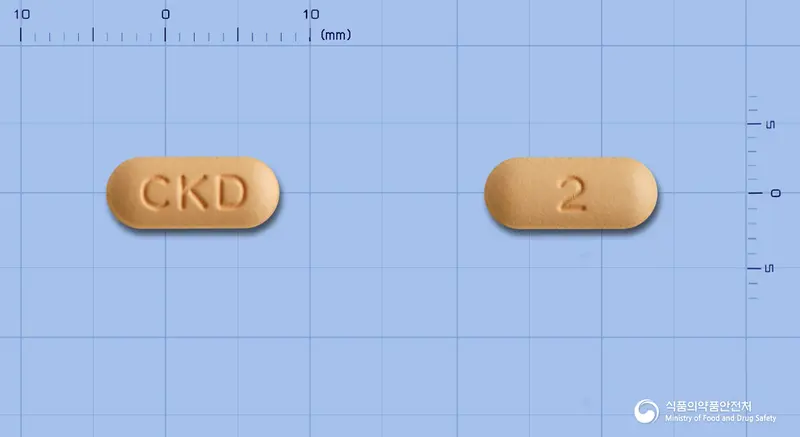 타크로벨정2밀리그램(타크로리무스수화물) 앞뒤 사진 (주황색 장방형, 각인 CKD / 2)