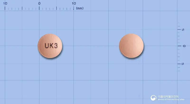 유니시움정20mg(에스오메프라졸마그네슘삼수화물) 앞뒤 사진 (분홍색 원형, 각인 UK3)