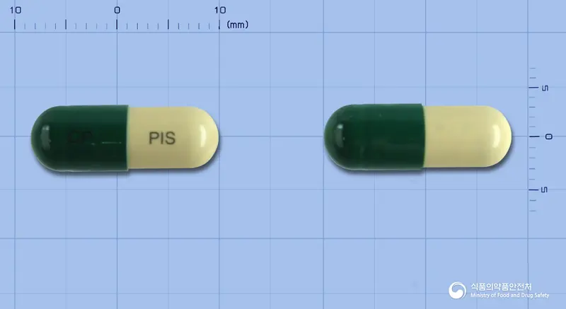 판이실캡슐 앞뒤 사진 (초록색 캡슐, 각인 CP PIS)