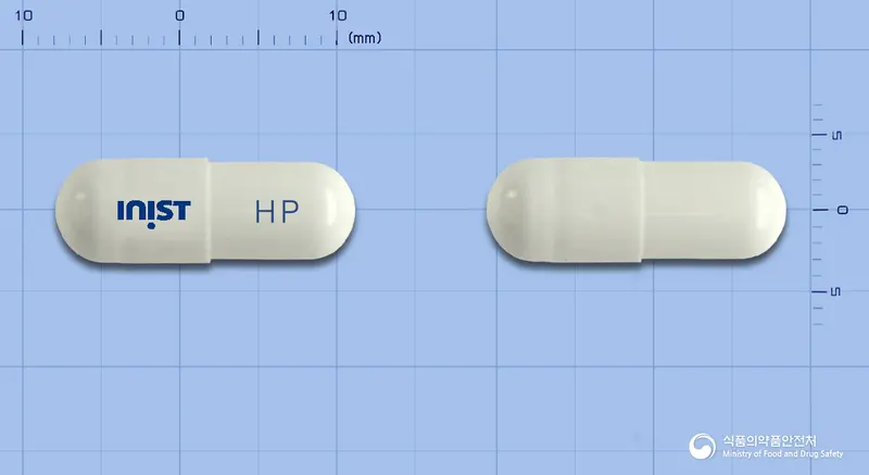 헤티스플러스캡슐 앞뒤 사진 (흰색 캡슐, 각인 HP)