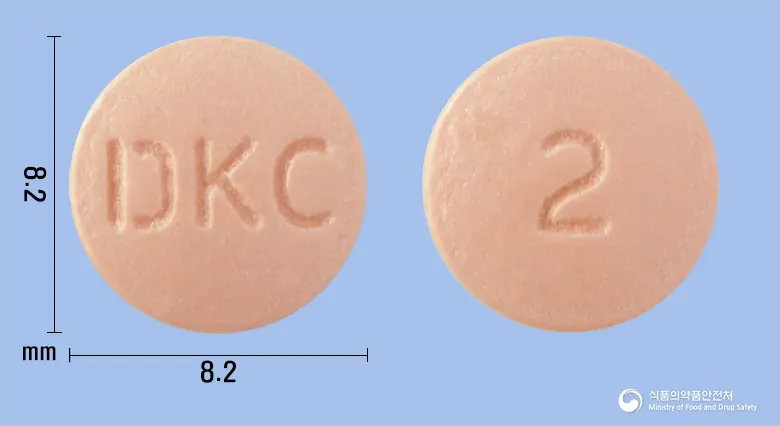 오메톤에스정20mg(에스오메프라졸마그네슘이수화물) 앞뒤 사진 (분홍색 원형, 각인 DKC / 2)