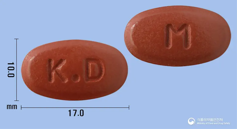 마이메가100정 앞뒤 사진 (갈색 타원형, 각인 K.D / M)