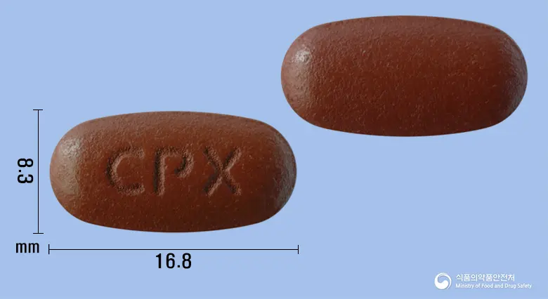 엑셀렌비정 앞뒤 사진 (갈색 타원형, 각인 CPX)