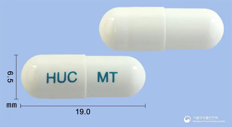 휴메틸캡슐 앞뒤 사진 (흰색 캡슐, 각인 HUC MT)