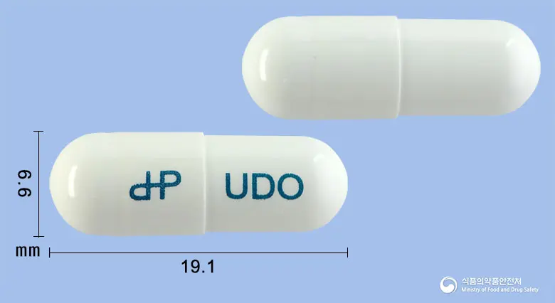 유디온캡슐 앞뒤 사진 (흰색 캡슐, 각인 UDO)