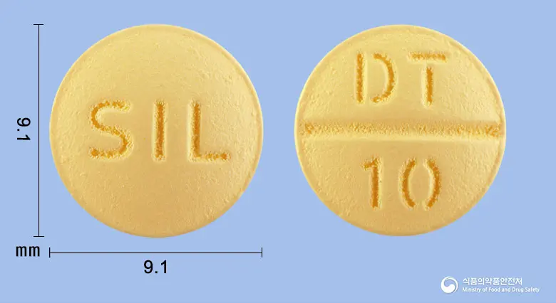 디멘케어정10밀리그램(도네페질염산염일수화물) 앞뒤 사진 (노란색 원형, 각인 SIL / DT 10)