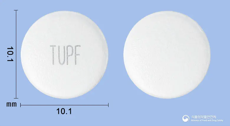 팜시아정(팜시클로비르) 앞뒤 사진 (흰색 원형, 각인 TUPF)