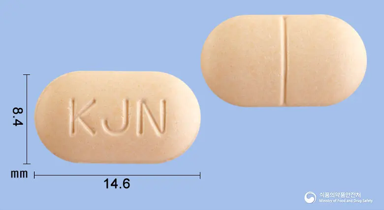 네오벤졸정(알벤다졸) 앞뒤 사진 (주황색 장방형, 각인 KJN)