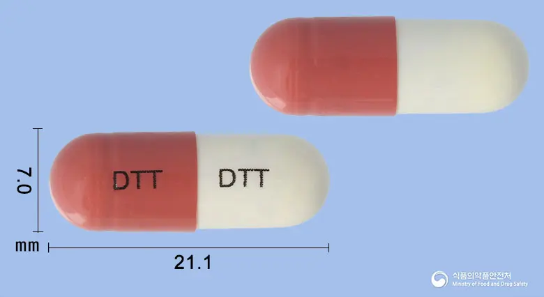 덴티텐캡슐(청위산) 앞뒤 사진 (주황색 캡슐, 각인 DTT DTT)
