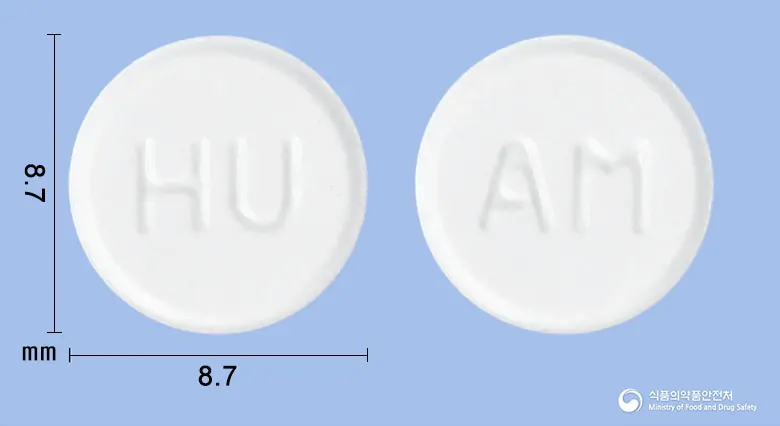 팜뮤코정(암브록솔염산염) 앞뒤 사진 (흰색 원형, 각인 HU / AM)