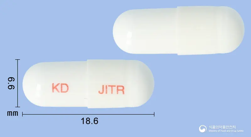 장이더락캡슐 앞뒤 사진 (흰색 캡슐, 각인 KD JITR)