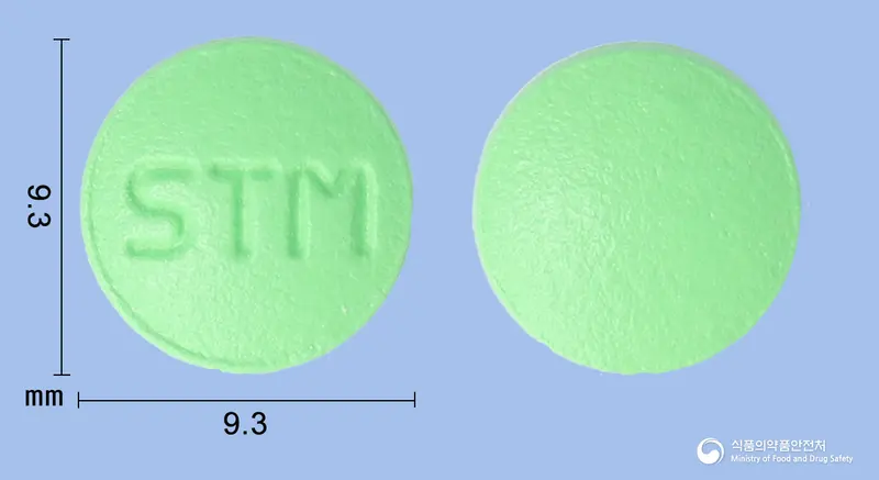 삼성트로멜라정 앞뒤 사진 (연두색 원형, 각인 STM)