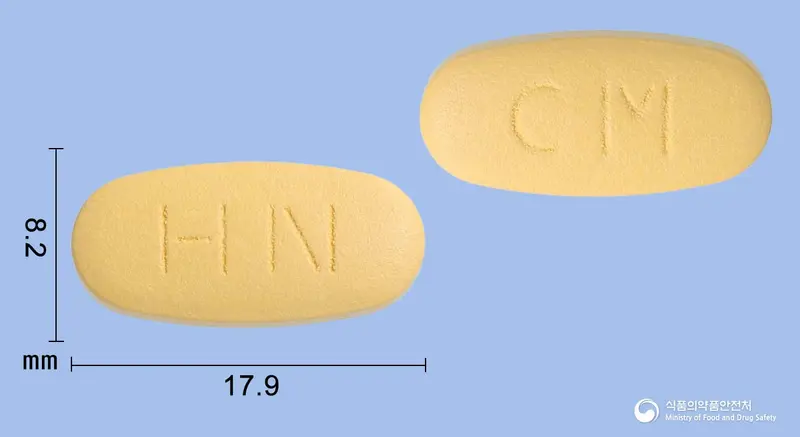 메가엑트정(시트룰린말산염) 앞뒤 사진 (주황색 타원형, 각인 HN / CM)
